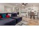 Open-concept living area with tile floors, a modern sofa, dining set, and a decorative china cabinet at 4627 W Laurie Ln, Glendale, AZ 85302