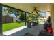 Covered patio featuring a ceiling fan and view of the backyard with green artificial turf at 4627 W Laurie Ln, Glendale, AZ 85302
