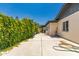 Side yard featuring stucco exterior and mature privacy landscaping at 4627 W Laurie Ln, Glendale, AZ 85302