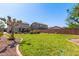 Well maintained backyard with large grassy area, lush landscape and a relaxing pool area at 509 S 111Th Dr, Avondale, AZ 85323