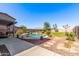 Beautiful backyard featuring a pebble tec pool, mature landscaping, and privacy fence at 509 S 111Th Dr, Avondale, AZ 85323