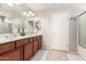Bathroom featuring double sinks, white countertops, and a shower/tub combination at 509 S 111Th Dr, Avondale, AZ 85323