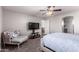 Bedroom featuring a ceiling fan, TV, chaise lounge, and plush carpeting at 509 S 111Th Dr, Avondale, AZ 85323