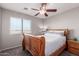 Bedroom with a ceiling fan, window, wooden bed frame, carpet, and dresser at 509 S 111Th Dr, Avondale, AZ 85323