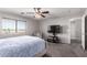 Bedroom with a ceiling fan, window, television, chair, and carpet at 509 S 111Th Dr, Avondale, AZ 85323