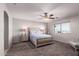 Comfortable bedroom with a ceiling fan, soft lighting, and ample space at 509 S 111Th Dr, Avondale, AZ 85323