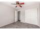 Bedroom with a ceiling fan, closet with doors, and neutral walls at 509 S 111Th Dr, Avondale, AZ 85323