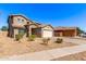 Charming two-story home boasts desert landscaping, a two-car garage, and a classic tile roof at 509 S 111Th Dr, Avondale, AZ 85323