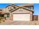 Charming two-story home with a two-car garage featuring decorative stone accents at 509 S 111Th Dr, Avondale, AZ 85323