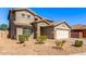 Charming two-story home with a two-car garage featuring decorative stone accents at 509 S 111Th Dr, Avondale, AZ 85323