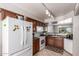 Functional kitchen layout featuring white appliances, and ample cabinet space at 509 S 111Th Dr, Avondale, AZ 85323