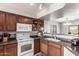 Open kitchen with white appliances, dark countertops, and a view into the dining area at 509 S 111Th Dr, Avondale, AZ 85323