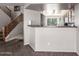 Open floor plan offering views of the kitchen with a breakfast bar and a staircase at 509 S 111Th Dr, Avondale, AZ 85323
