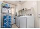 Laundry room with a washer, dryer, storage racks, and shelves at 509 S 111Th Dr, Avondale, AZ 85323