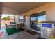 Relaxing covered patio with grill, table, chairs, and sliding glass door at 509 S 111Th Dr, Avondale, AZ 85323
