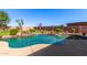 Beautifully landscaped backyard featuring pebble tec pool with rock waterfall feature at 509 S 111Th Dr, Avondale, AZ 85323