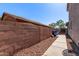 Long and narrow side yard with a block wall and walkway at 509 S 111Th Dr, Avondale, AZ 85323