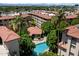 Aerial view of pool with palm trees and buildings at 5104 N 32Nd St # 114, Phoenix, AZ 85018