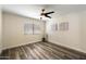 Bright bedroom with wood floors, ceiling fan, window with blinds, and modern decor at 5104 N 32Nd St # 114, Phoenix, AZ 85018
