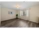 Cozy bedroom with natural light, wood-look flooring, and minimalist decor at 5104 N 32Nd St # 114, Phoenix, AZ 85018