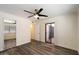 Bedroom with wood floors, ceiling fan, open door and sliding glass door at 5104 N 32Nd St # 114, Phoenix, AZ 85018
