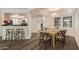 Bright dining room featuring wood floors, a modern table, and views of the kitchen at 5104 N 32Nd St # 114, Phoenix, AZ 85018