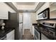 Efficient kitchen featuring stainless steel appliances and granite countertops next to laundry area at 5104 N 32Nd St # 114, Phoenix, AZ 85018