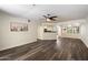 Open living space with hardwood floors, ceiling fan and partial kitchen view at 5104 N 32Nd St # 114, Phoenix, AZ 85018