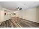 Open living room featuring neutral walls, modern ceiling fan, and stylish wood-look flooring at 5104 N 32Nd St # 114, Phoenix, AZ 85018