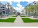Community space with artificial turf, paved walkways, seating areas, palm trees, and a fire pit at 5250 E Deer Valley Dr # 146, Phoenix, AZ 85054