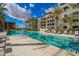 Resort-style community pool with lounge chairs, palm trees, and well-maintained landscaping on a sunny day at 5250 E Deer Valley Dr # 146, Phoenix, AZ 85054
