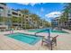 Beautiful community pool area with spas, seating areas, palm trees, and clear blue skies for relaxation and enjoyment at 5250 E Deer Valley Dr # 146, Phoenix, AZ 85054