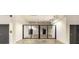 Bright hallway featuring a secure metal security gate, doors on both sides, and overhead lighting at 5250 E Deer Valley Dr # 146, Phoenix, AZ 85054