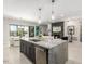 Modern kitchen with a large island, dark cabinets, and stainless steel appliances at 5250 E Deer Valley Dr # 146, Phoenix, AZ 85054