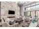 A stylish lounge features high ceilings, large windows, a marble wall, a fireplace, modern furniture, and elegant decor at 5250 E Deer Valley Dr # 146, Phoenix, AZ 85054