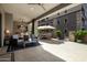 Spacious outdoor patio with comfortable seating, kitchen, ceiling fans, and a table with umbrella for year-round enjoyment at 5250 E Deer Valley Dr # 146, Phoenix, AZ 85054