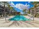 An expansive swimming pool is surrounded by lounge chairs and palm trees, offering a resort-like experience on a sunny day at 5250 E Deer Valley Dr # 146, Phoenix, AZ 85054