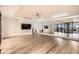Bright yoga studio with a large mirror, wall-mounted TV, ceiling fan, and wooden floors at 5250 E Deer Valley Dr # 146, Phoenix, AZ 85054