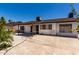 Large backyard with a patio, lawn area, and mature trees, perfect for outdoor relaxation and activities at 5432 W Sunnyside Dr, Glendale, AZ 85304