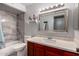 Bathroom featuring modern tiling around shower/tub and a large mirror over sink at 5432 W Sunnyside Dr, Glendale, AZ 85304
