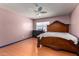 Bedroom showing hardwood floors, large bed, dresser, and ceiling fan at 5432 W Sunnyside Dr, Glendale, AZ 85304