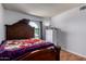 Well-lit bedroom featuring an arched window, bed, and storage unit at 5432 W Sunnyside Dr, Glendale, AZ 85304