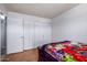 Bedroom featuring a bed, closet, and a doorway to another room at 5432 W Sunnyside Dr, Glendale, AZ 85304