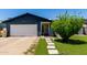 Charming home featuring an attached garage, front yard landscaping, and a welcoming entrance at 5432 W Sunnyside Dr, Glendale, AZ 85304