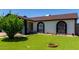 Charming home with tidy front synthetic lawn, manicured landscaping, and decorative accents, showcasing curb appeal at 5432 W Sunnyside Dr, Glendale, AZ 85304