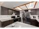 Well-equipped kitchen with dark cabinetry, stainless steel appliances, and ample counter space at 5432 W Sunnyside Dr, Glendale, AZ 85304
