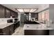 Modern kitchen featuring sleek countertops, dark cabinets, and stainless steel appliances at 5432 W Sunnyside Dr, Glendale, AZ 85304