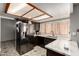 Modern kitchen featuring sleek countertops, dark cabinets, and stainless steel appliances at 5432 W Sunnyside Dr, Glendale, AZ 85304