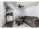 Cozy living room features a comfortable sofa, patterned tile flooring and an indoor treadmill at 5432 W Sunnyside Dr, Glendale, AZ 85304