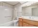 Cozy bathroom featuring a tiled tub/shower combination and a light wood vanity at 7910 E Navarro Ave, Mesa, AZ 85209